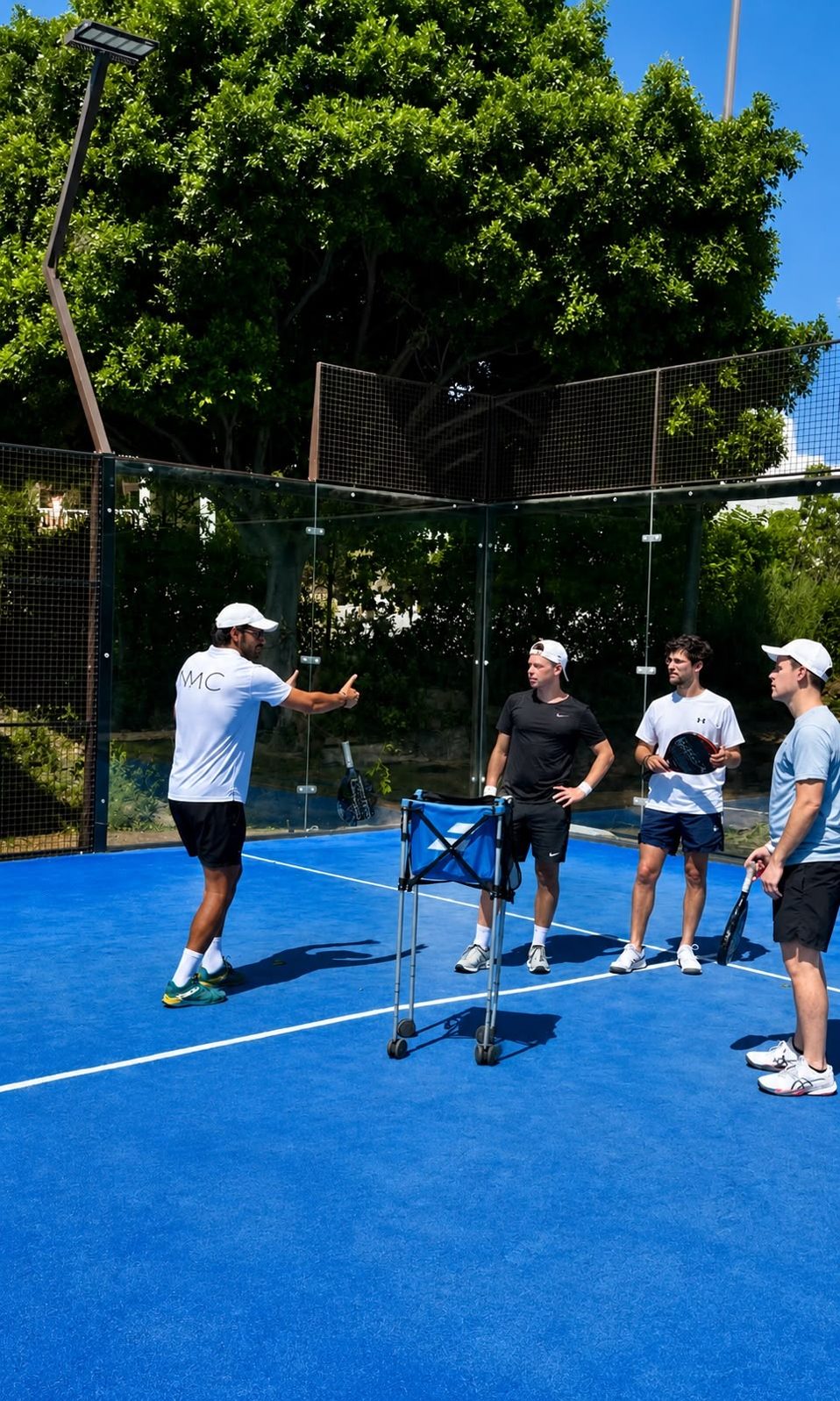 A coach giving instructions to a group of players on court